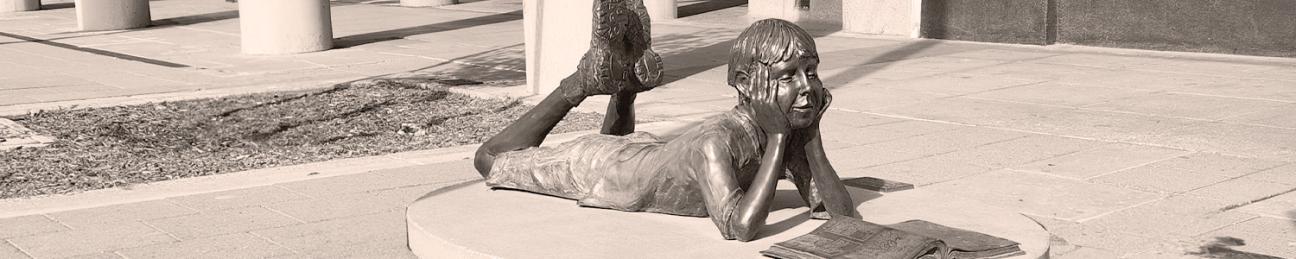 Sculpture of boy reading book