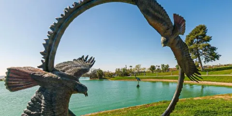 Artificial desert pond with landscape and circular bird sculpture