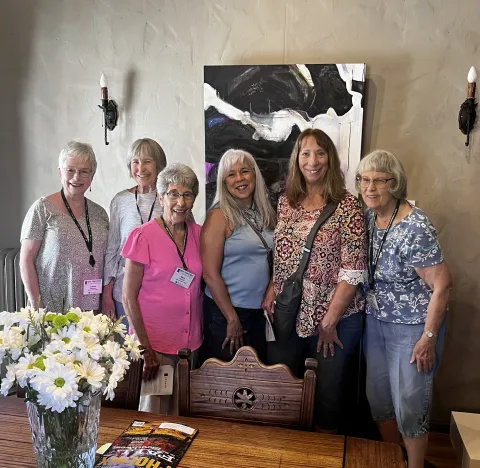 group standing in front of painting